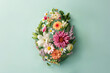 Easter egg shape made with flowers on mint background. Holiday concept.