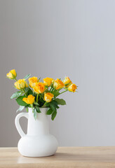 Wall Mural - yellow roses in white jug on wooden shelf