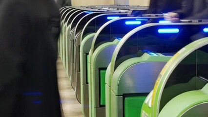 Canvas Print - Close up view of the ticket gate in the train station with many passenger get through the ticket gate in rush hour