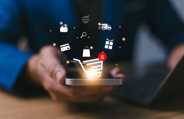 Businessman using smartphone with virtual graphics with business ecommerce and trolley cart icons, Technology online shopping business concept. Internet network online shop store. Notification alert.