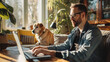 © EmmaStock - Mature handsome man stylish using a laptop in the living room with dog