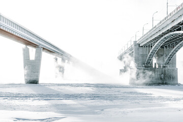 Wall Mural - Bridge is over frozen river. Embankment of the Ob river in winter in Novosibirsk frost day -40 degrees Celsius