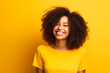 © Pierre - Portrait of smiling beautiful African American young woman. Yellow background.