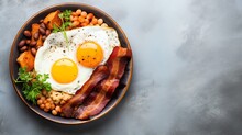 A Plate Of Food With Eggs Bacon And Beans