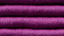  A Close Up Of A Purple Thread With A Lot Of Spools Of Thread In The Middle Of It.