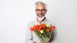 © Irina - Brutal gray-haired man with a bouquet of Tulips. International Women day, Mother Day concept. valentine's day, copy space, Image for advertising, Banner, Magazines