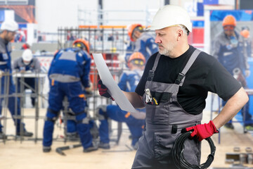 Poster - man is factory foreman. electrician holds sheet paper. foreman of industrial enterprise. factory emp