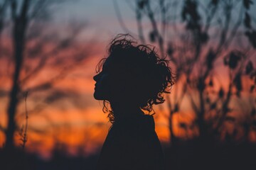 Poster - A simple and elegant silhouette of a person with long hair. This image can be used to depict beauty, mystery, and individuality