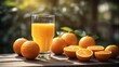 Glass of orange juice, fresh juicy oranges on a table in the garden, healthy summer morning drink