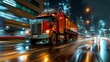 A truck driving down a city street at night, with bright headlights illuminating the road and surrounding buildings.