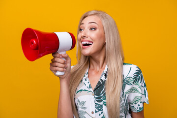 Wall Mural - Photo of overjoyed girl with long hairdo dressed print shirt scream in loudspeaker look empty space isolated on yellow color background