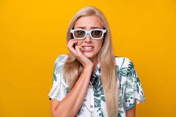 Sticker - Photo of frightened girl with long hairdo dressed shirt in 3d glasses watch horror biting fingers isolated on yellow color background