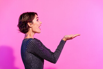 Poster - Photo of shiny impressed lady wear glamour outfit looking holding arms empty space isolated vivid pink color background