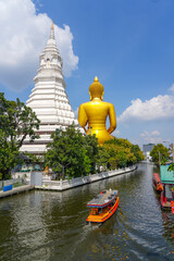 Big Buddha Wat Paknam Chao Phraya river canal cruise. Tourists traveling by traditional boats. Thailand's most important travel destinations. Bangkok, Thailand