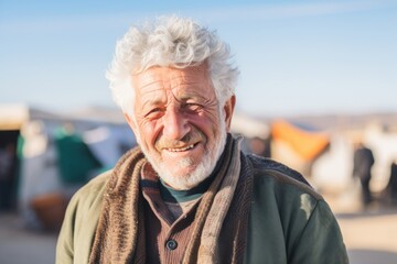 Portrait of an old man with white hair and beard in the countryside