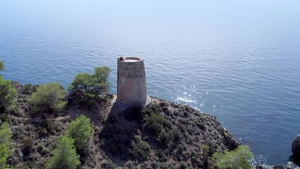 Wall Mural - Orbit aerial view of medieval ruins next to the cliffs.Medieval watchtower over the cliffs on the Mediterranean coast. Andalusia. Spain.
