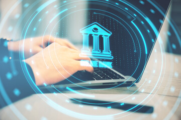Poster - Close up of businessman using laptop on desk with pen and creative round hologram with bank on blurry background. Money, online banking and finance concept. Double exposure.