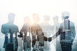 © Who is Danny - Abstract city skyline with businesspeople silhouettes on light background. Teamwork, partnership and success concept. Toned image. Double exposure.