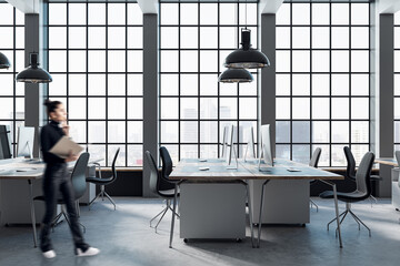 Aufkleber - Woman walking in modern coworking office interior with large panoramic windows with city view, lamps, concrete flooring and other objects.