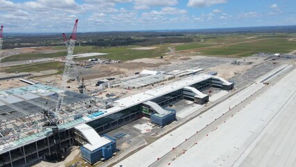 Wall Mural - Aerial drone pullback reverse view of the construction site of the new Western Sydney International Airport at Badgerys Creek in Western Sydney, NSW on a sunny day shot on 23 December 2023