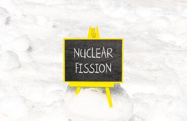 Wall Mural - Nuclear fission symbol. Concept words Nuclear fission on beautiful black chalk blackboard. Chalkboard. Beautiful snow background. Business science nuclear fission concept. Copy space.