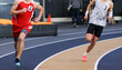 © coachwood - Two boys running a race on an indoor track