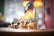 flock of ducklings under heat lamp