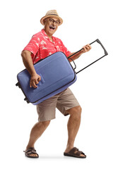 Canvas Print - Happy mature male tourist dancing with a suitcase