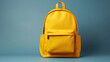 ©  Mohammad Xte - Yellow school backpack with books. Isolated on blue background