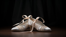 White Ballet Shoes With Ribbons, Set Against A Dark Background On A Wooden Surface. Ballet Shoes Is White, With Elegant Ribbons Tied In Bows. Dark Wooden Surface And Black Curtain Backdrop. 