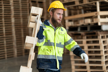 Caucasian businessman carry pallets wood at warehouse	