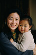 asian/korean/chinese mother and daughter/child in loving embrace smiling joy motherhood mothers day in editorial magazine portra film look