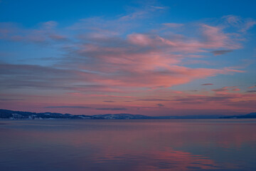 Sticker - Evening light by Lake Mjosa and of rural Toten, Norway, in December.