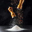 Salt and pepper mills in mid-air