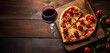 Pizza in the shape of heart with wine for St. Valentine's Day