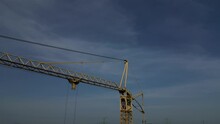 The Camera Zooms In And Out Of The High-rise Crane. Checking The Crane Operator To See If He Fell Asleep Or Died. Drone Operator Is Suitable For Checking The Condition Of Cables In Hard-to-reach Place