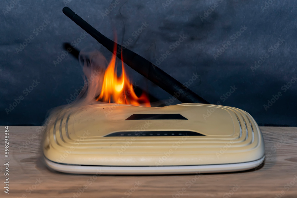 Wi-fi router burns with fire from overheating and smoke on the dark ...