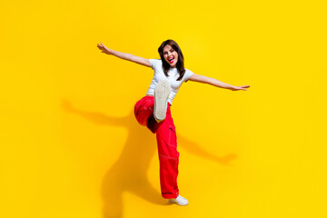 Poster - Full length photo of funky cool woman dressed white t-shirt arms sides walking dancing discotheque isolated yellow color background