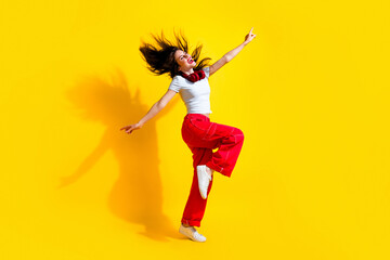 Sticker - Full length photo of sweet dreamy woman dressed t-shirt headphones flying hair arms sides having fun discotheque isolated yellow color background