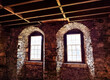 medieval windows located in an old building , natural light and shade 