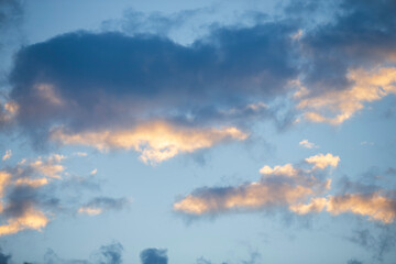 Wall Mural - Cloudscape, Colored Clouds at Sunset near the Ocean on a Blue Sky