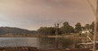 Panoramic image of a broken windmill standing in the still water of a lake, local water supply, with a smoky sky overhead from a nearby bushfire. Tamworth, rural NSW, Australia
