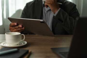Poster - Digital tablet computer close up man using tablet hands man multitasking with isolated screen