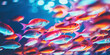 A dynamic school of neon tetra fish swimming in unison against a backdrop of deep blue aquarium water.