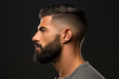 A profile view of a man sporting a trendy fade haircut with a well-groomed beard, epitomizing modern urban masculinity. Male, 34 years old, Middle Eastern ethnicity