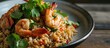 Asian-style fried rice with seasoned shrimp and herbs.