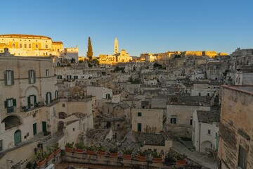 Poster - view of the old city center of Matera with the stone houses in the last rays of sunlight