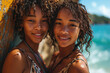 Young black Female twins taking a break from surfing to take a selfie on the beach while leaning against a wall.