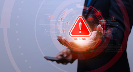 businessman showing warning icon, exclamation mark,alarm,computer virus detected,danger warning concept or information error that should be urgently fixed and repaired,Notification of security issues