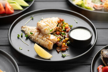 Flat lay view of variety of grilled fish dishes served on table in restaurant